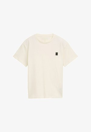 Cremefarbenes T-Shirt mit kurzen Ärmeln aus Baumwolle, das ein kleines schwarzes Quadrat-Logo auf der linken Brustseite zeigt. Klassischer Rundhalsausschnitt.