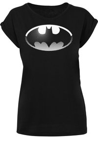 Svart T-skjorte med en stor hvit Batman-logo i prikkete design. Korte ermer, rund hals, laget av mykt stoff.