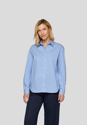 Blue and white striped button-up shirt with a collar, long sleeves, and a relaxed fit, made from a smooth fabric. Paired with dark pinstriped pants.