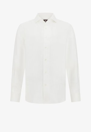 Ilga piedurkne balta krekls, kas izgatavots no viegla auduma, ar klasisku apkakli, priekšējo pogu aizdari un nedaudz izliekamu apakšu.