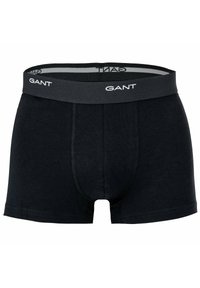 Boxer neri con una fascia elastica grigia che presenta il nome del marchio "GANT" in bianco. Realizzati in un materiale morbido e elastico.