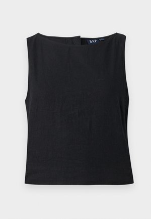 Haut noir sans manches pour femme avec encolure bateau et fermeture éclair latérale, tissu uni, étiquette de la marque GAP visible à l'intérieur du col.