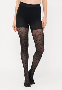 Sorte strømpebukser med et gennemsigtigt leopardprint design. Den øverste sektion er tætsiddende, mens den nederste halvdel har en semitransparent tekstur.