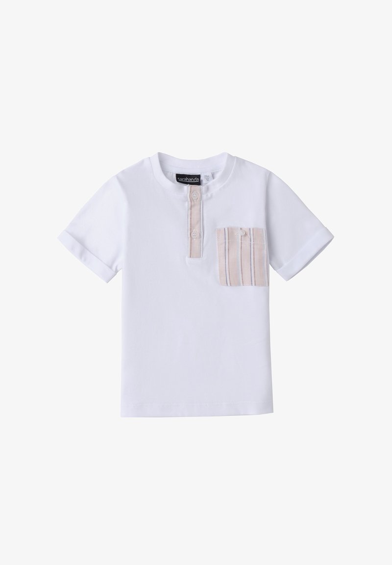 Camiseta blanca de manga corta con escote redondo, presenta un pequeño bolsillo de rayas claras en el lado izquierdo y una tapeta de botones parcial.