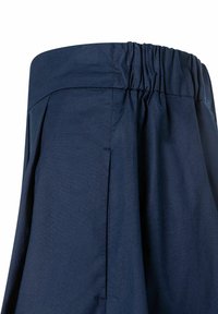 Marineblauwe wijde broek met een elastische tailleband, voorzien van plooien aan de voorkant en een gladde, gestructureerde stof.