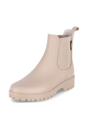 Beżowy gumowy trzewik za kostkę z masywną podeszwą, elastycznymi panelami bocznymi i pętelką z tyłu dla łatwego zakładania.