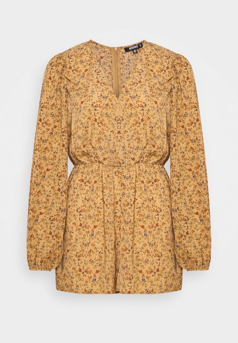 Blouse jaune moutarde à motifs floraux avec manches longues bouffantes, encolure en V, taille froncée et fermeture éclair au dos. Présente de petits motifs floraux rouges et bleus.