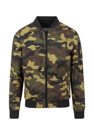 Kamuflāžas bombjera jaka zaļās un brūnās krāsās ar rāvējslēdzēja aizdari priekšpusē, ribotām aprocēm un kabatu ar aplikāciju uz piedurknes.