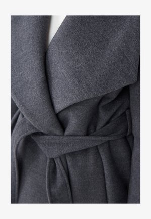 Gray wool wrap coat featuring a wide collar, belted waist, and soft, textured fabric. Visible folds and a structured silhouette.