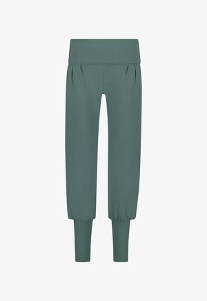 Pantalons de jogging teal en tissu doux, avec une large ceinture, des plis et des poignets resserrés aux chevilles. Texture lisse et coupe décontractée.