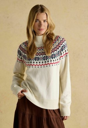 Cremefarbener Pullover mit hohem Rippkragen, der ein mehrfarbiges geometrisches Muster über die Schulterpartie aufweist. Weicher Strickstoff.