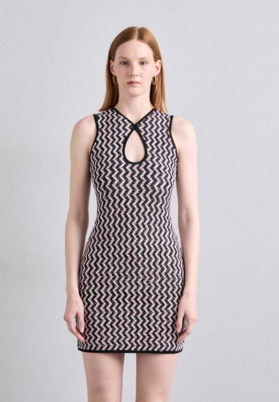 Knit sleeveless dress with a black, pink, and white zigzag pattern. Features a round keyhole opening at the neckline and fitted silhouette.