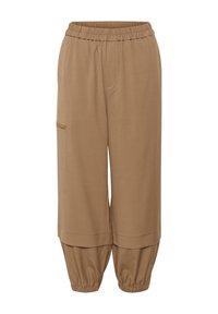 Pantalon marron ample avec taille et poignets élastiques, avec une poche latérale sur la jambe gauche.