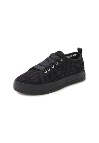 Black sneaker with a lace overlay texture, flat rubber sole, round toe, and flat laces threaded through silver eyelets.