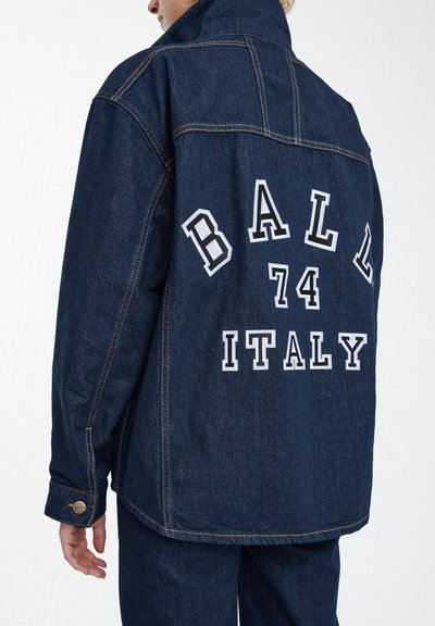 Tmavomodrá džínová bunda s vysokým golierom, veľkým bielym textom "BALL 74 ITALY" na chrbte a kontrastnými oranžovými švami.
