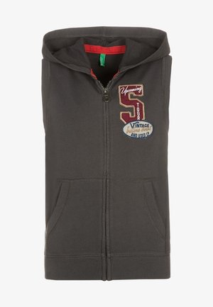 Sweat à capuche sans manches gris foncé avec fermeture éclair, poches avant et patchs brodés indiquant "Upcoming S Tour" et "Vintage And Used LP".