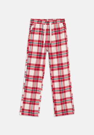 Pantalons de pyjama à carreaux rouges et blancs avec des accents verts, taille élastique, cordon de serrage et poches latérales posés à plat sur un fond blanc.