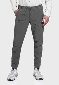 Graue Sporthose aus leichtem Material mit elastischem Taillenbund und Zugband, seitlichen Taschen und slim fit Design.
