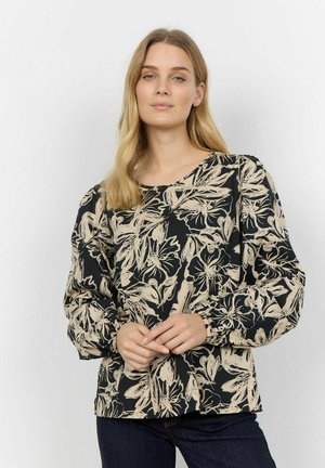 Blouse à motif floral noir et beige, avec des manches ballon longues et un col arrondi. Tissu doux avec une coupe décontractée.