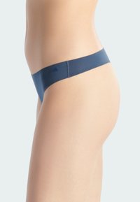 Navyblauwe string gemaakt van soepel stof. Kenmerkt zich door een zachte, brede tailleband en minimale bedekking, waardoor het slanke ontwerp wordt benadrukt.