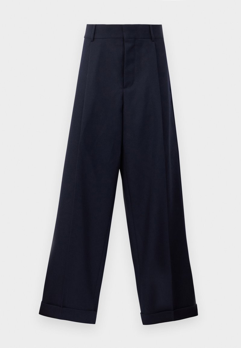 Navy wide-leg trousers with a high waist, crisp pleats, and a smooth texture. Roll-hem detailing at the cuffs enhances the design.