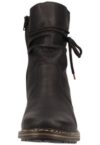 Black leather ankle boot with a rounded toe, side zipper, and decorative lace detail. Features a textured surface and contrasting stitched trim.