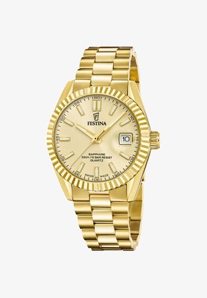 Guld Festina armbåndsur med riffelrunde bezel, gul urskive, lysende markører, datovisning kl. 3 og metalledsarmbånd.