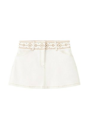 White denim mini skirt with front pockets and a studded belt featuring a symmetrical diamond and line pattern.