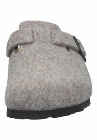 Brown felt clog with a rounded toe, flat sole, and a strap across the top with a metal buckle. Soft texture and minimal design details.