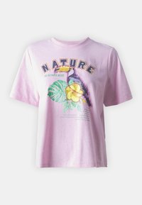 Pink cotton t-shirt with a relaxed fit. Features a graphic design of a toucan and a flower, with “NATURE” text in bold typography.