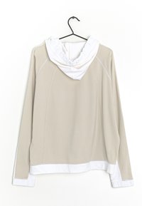 Hoodie beige avec des accents blancs, présentant une capuche froncée, des manches longues et une finition texturée. Détails de couture visibles sur l'ensemble.