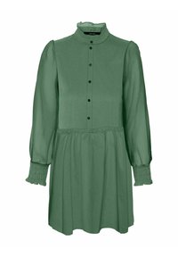 Zielona, długa sukienka z długim rękawem, falbaniastym dekoltem, zapięciem na guziki, elastycznymi mankietami i rozkloszowanym dołem. Wykonana z gładkiego materiału.