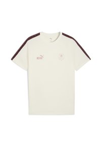 Tricou crem cu mâneci raglan, având accente cu model în nuanțe de vișiniu, logo-ul "KING" în roz deschis și un logo în formă de scut pe partea stângă a pieptului.