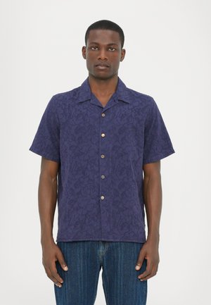 Chemise à manches courtes en bleu marine avec un motif floral, fermeture à boutons et coupe décontractée. Fabriquée en tissu léger avec une texture douce.