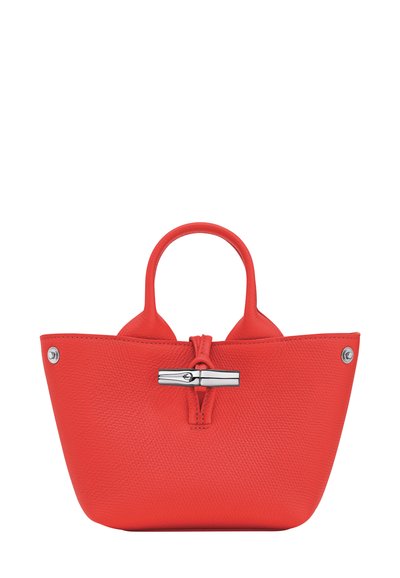 Small bright red leather handbag with rounded handles and a silver clasp closure on a white background.