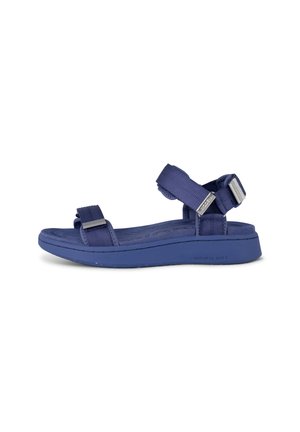 Purple sandal with two adjustable fabric straps and a textured sole. Features a cushioned footbed and a lightweight, flexible design.