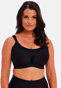 Sort sportsbh med en netpanel og polstrede kopper, med brede stropper og en kontureret design for støtte og komfort.