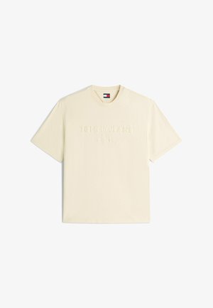 Cream short-sleeve crew neck T-shirt with embossed "Tommy Jeans" text and small Tommy Hilfiger flag logo on inner collar.
