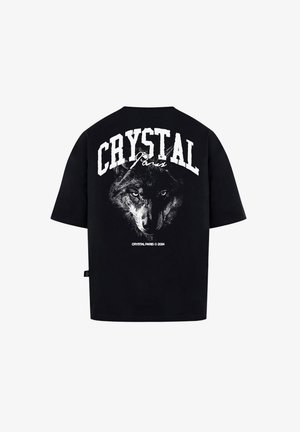 Czarna, oversize koszulka z grafiką wilka oraz napisem "CRYSTAL Paryż" dużymi białymi literami na plecach. Wykonana z miękkiej bawełny.
