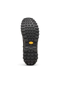 Musta kumipohja, jossa syvät uritukset ja pyöreät kuviot. Keskellä keltainen yksityiskohta, jossa "vibram"-brändäys.