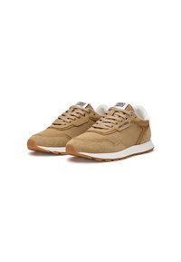 Tan sneakers with mesh and suede materials, featuring a white sole, lace-up design, and black logo on the tongue. Textured surfaces present.