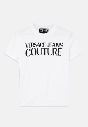 White cotton t-shirt featuring bold black lettering that reads "VERSACE JEANS COUTURE" across the front, with a classic crew neckline.