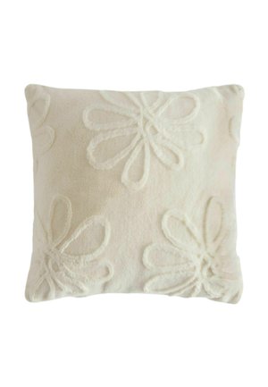Square beige cushion with raised floral patterns creating texture on the fabric surface.