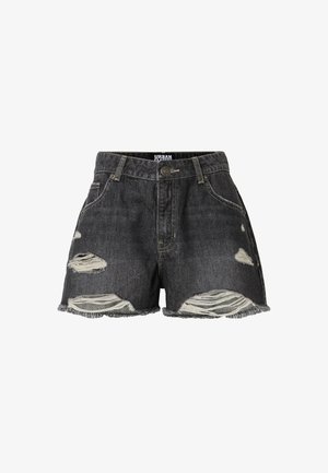 Mustad teksapüksid lõhkiste äärtega, ees kulunud laikudega, klassikalise viie taskuga ja vöökoha nupuga kinnitusega.