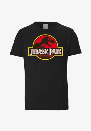 Mustan puuvillapaidan etuosassa on suuri punainen ja keltainen pyöreä grafiikka, jossa on dinosauruksen ääriviivat ja teksti "Jurassic Park."
