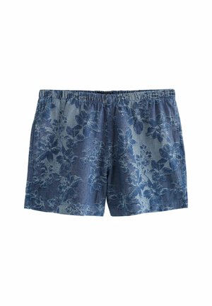 Pantalones cortos de mezclilla azul con un estampado floral, que presentan una cinturilla elástica y un ajuste relajado, con diseños florales claros y oscuros a lo largo.