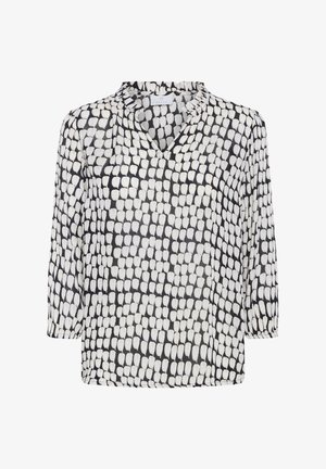 Blusa bianca e nera con scollo a V, maniche a tre quarti e un motivo testurizzato di forme a goccia sovrapposte. Tessuto leggero.