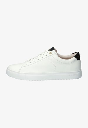 White leather sneaker with a sleek design, rounded toe, flat white sole, black heel accent, and flat white laces. Features a logo on the heel.