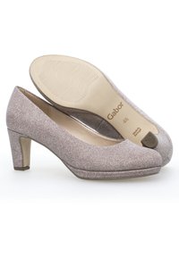 Tacchi alti beige con texture, punta arrotondata e tacco a blocco di altezza media. Presentano una fodera morbida e un logo impresso sulla soletta.