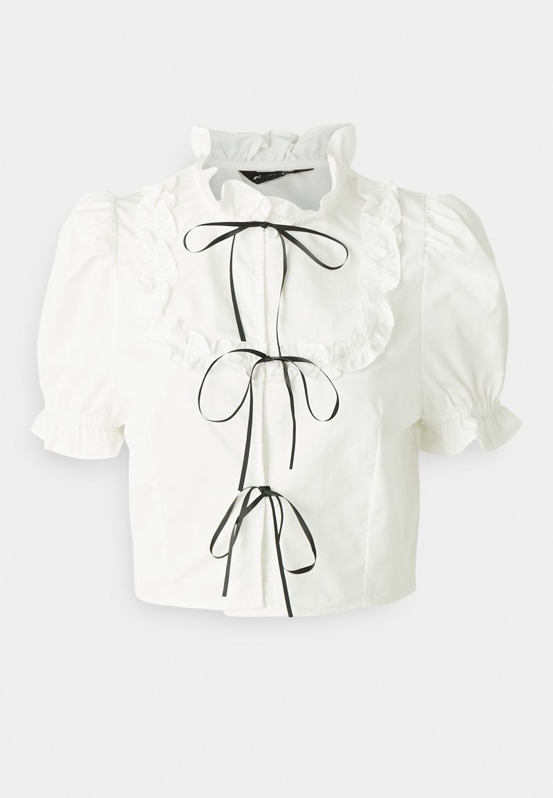 Blouse blanche à manches courtes avec col à volants, liens en satin noir et fermetures à boutons ; fabriquée en tissu en coton lisse.